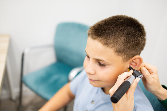 A child between 10 and 12 years old during an ear examination with an otoscope in an otolaryngology clinic. Concept of ear infection prevention in children