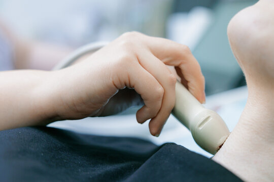 Medical ultrasound neck scan with probe on patient for carotid imaging and vascular diagnostic