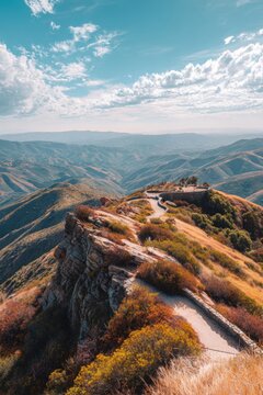 Mountain trail leading to a scenic viewpoint on a high summit. Dramatic landscape with rolling hills and blue sky. Hiking destination for nature travel, outdoor adventure and exploration.