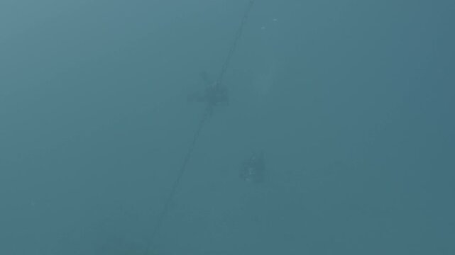 log footage of an airplane wreck underwater scuba divers to explore  metal on ocean floor