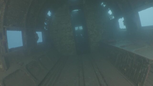 log footage of an airplane wreck underwater scuba divers to explore  metal on ocean floor