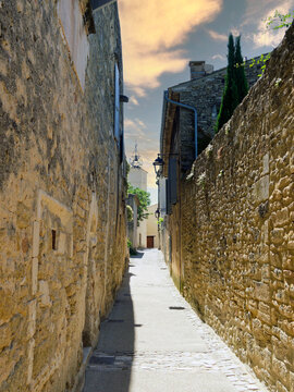 M&eacute;nerbes in Vaucluse, one of the Most Beautiful walled Villages of France located in the heart of Luberon. Narrow Church Street between Clock Tower and Square of Church of Saint Luke