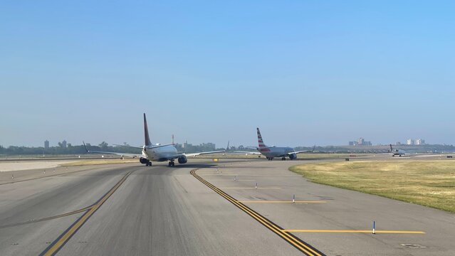 Planes on the runway at JFK, waiting for takeoff on July 2, 2026 in Howard Beach, New York