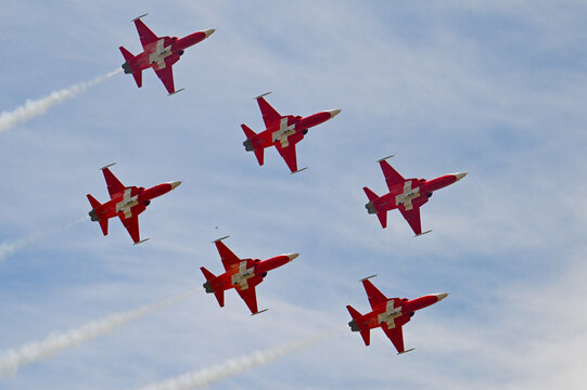 Grenchen, Switzerland - 11.07.2026: Patrouille Suisse aerobatic team flies tight formation with smoke trails during airshow display.