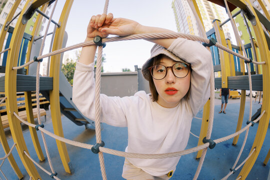 Person Plays on Climbing Structure in Urban Playground