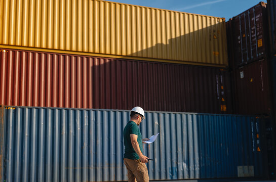 Logistics Supervisor Using Two-Way Radio at Container Shipping Yard