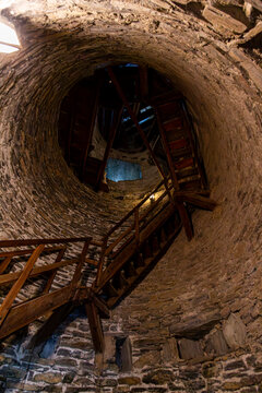Martigny, Valais, Switzerland - August 11th, 2025: Interior of the round tower of the historic Ch&acirc;teau de la Batiaz, featuring the wooden staircase that leads to the top of the castle.