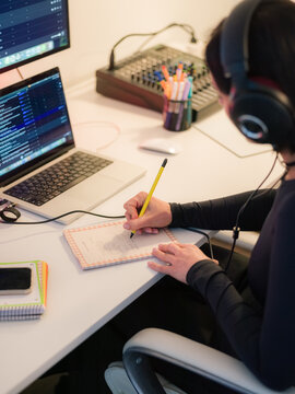 Woman taking notes in notebook at office 