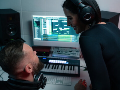 Musicians looking at each other and smiling at studio 