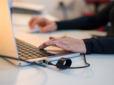 Person using laptop at office desk 