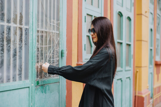 Woman Pretending to Knock on Vintage Window