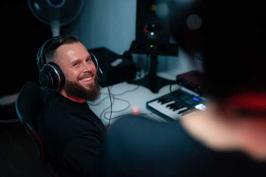 Man looking at woman and smiling at sound recording studio 