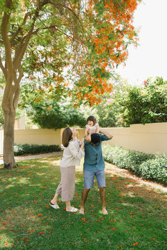 Father and mother with a little daughter in the park