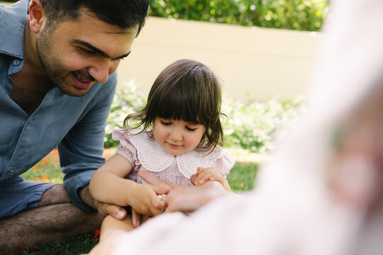Father and mother with a little daughter in the park