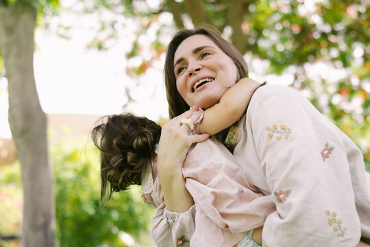 Happy mother with a little girl outdoors