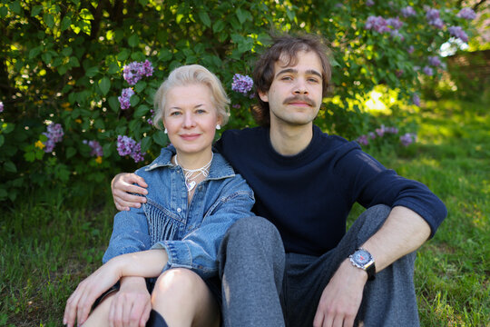 mother with older son walking spending time in the park