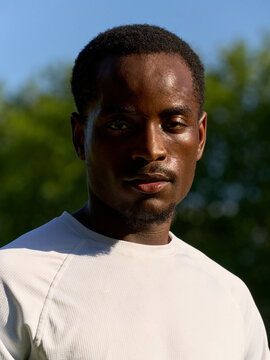 Man in White Shirt Standing Outside on Sunny Day