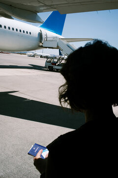 Passenger Prepares for Departure at the Airport With Passport in Hand
