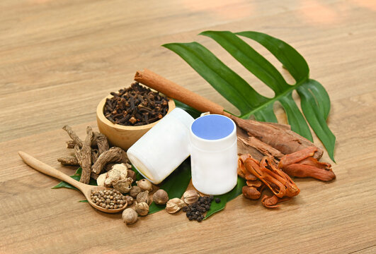 Traditional Thai herbal ingredients used in an ancient Thai inhaler recipe, featuring aromatic medicinal plants and natural remedies on a rustic wooden background.