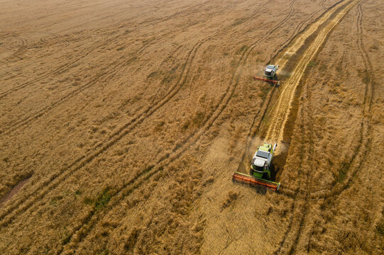 Aerial view of combine harvester in wheat field