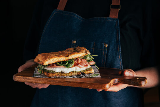 Rustic Italian focaccia served on wooden board by chef