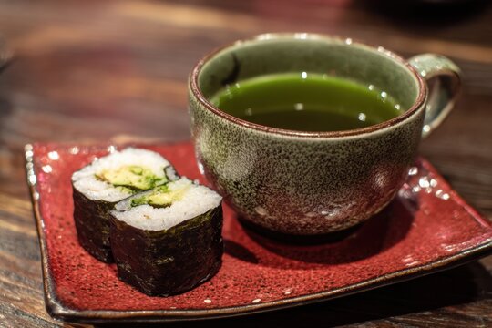 Japanese avocado maki sushi with green tea