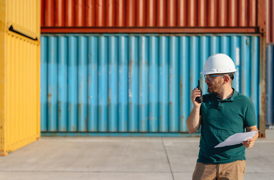 Logistics Supervisor Using Two-Way Radio at Container Shipping Yard