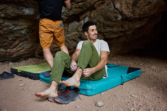 Climbers prepare for a bouldering session inside a cave