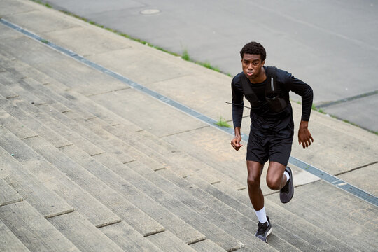 Runner Climbs Stairs in Urban Setting During Daylight Hours