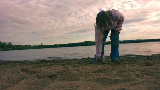 Woman drawing a line in the sand at beach