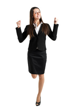 Joyful young female professional in business attire raising her