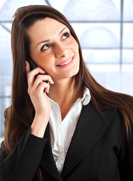 Professional woman on call in office setting