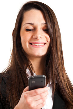 Young professional woman smiles while looking at her mobile phon