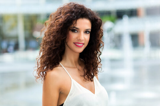 Radiant woman with curly hair outdoors