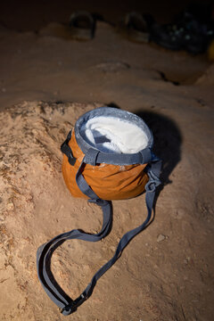 Climbing chalk bag rests on the ground during night climbing