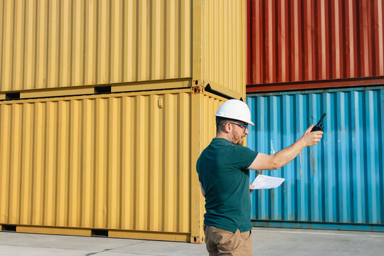 Logistics Supervisor Using Two-Way Radio at Container Shipping Yard