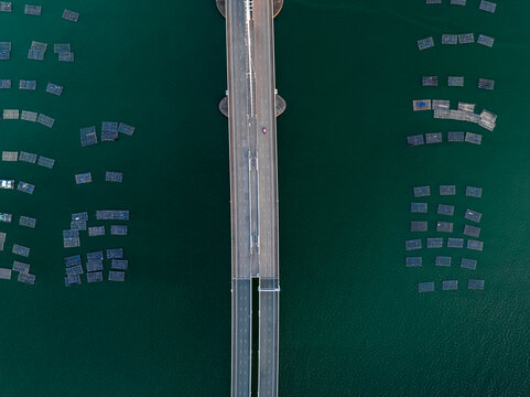 Top-Down Aerial View of Bridge Over Marine Farms