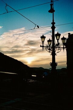Ornate Street Lamp Silhouette at Sunset in a European City