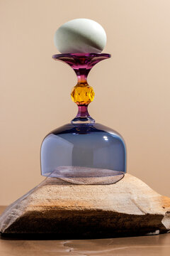 Egg on colored glass on a stone