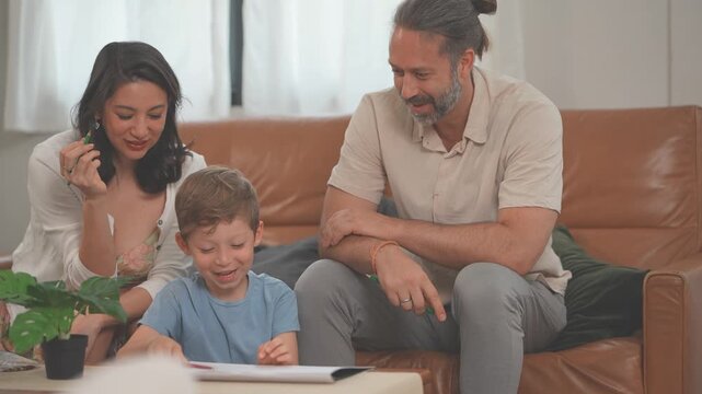 Happy multicultural family drawing and colouring together with crayons and paper