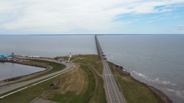 Aerial view of Confederation Bridge PEI, semi-truck driving on long bridge over ocean