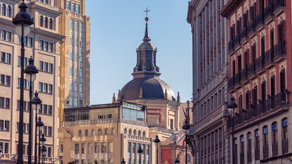 Fototapeta premium View along Sevilla Street toward the church dome and historic buildings in Madrid Spain