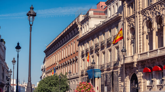View along Alcala Street with the Metropolis Building and historic architecture in central Madrid Spain.