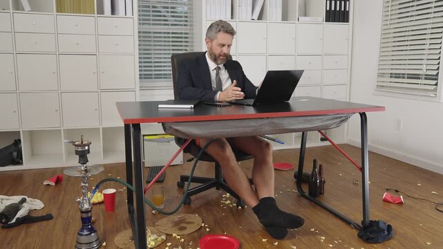 Comic Businessman. Business man during a video conference in messy office. Crazy and funny business concept. Fun business team online. Humor in business. Messy funny office workspace.