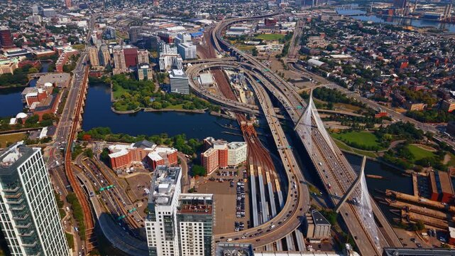 Leonard P. Zakim Bunker Hill Memorial Bridge and the surrounding urban scenery of Boston, Massachusetts. The iconic cable-stayed bridge across the Charles River with lively traffic.