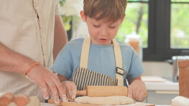 Family shaping and cutting dough on a floury worktop during a playful baking session