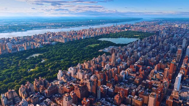 Heading to the lush greenery of Central Park in New York City, USA. Vast city panorama under the cloudy sky at sundown.