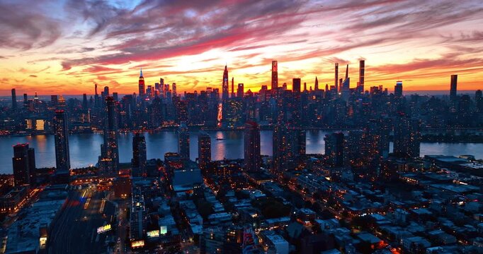 Dusk time in modern New York City, USA. Fantastic colorful sky over the urban panorama.