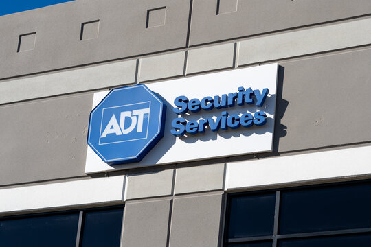 Irving, Texas, USA - March 20, 2022: ADT Security Services sign on the office building in Irving, Texas, USA. ADT Inc. is an American company that provides alarm monitoring services. 