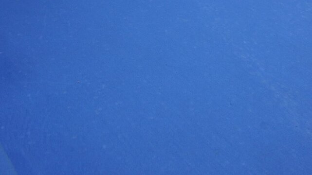 some one is  playing billiard. Billiard tabel is blue